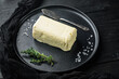 Dairy butter, on black wooden table background