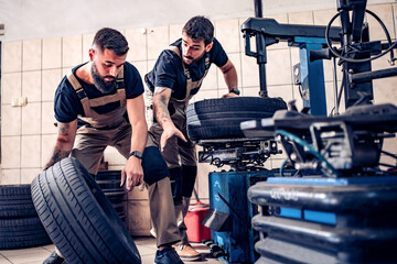 Car mechanics working in auto repair service