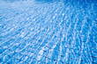 Blue water background. Abstract summer sea pattern. Pool water surface or wave texture.