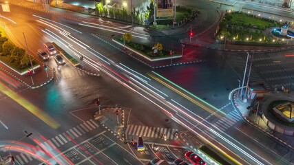 Poster - Time lapse of aerial view of intersection or junction with cars traffic, Bangkok Downtown. Thailand. Financial district in smart urban city and technology. Skyscraper office buildings at night