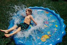 Child Playing In Kiddie Pool
