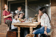 © Mal de Ojo Studio/Stocksy - Family eating snacks together