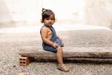Baby Girl Portrait On A Wooden Bench At Backyard