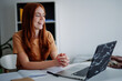 © Oleksii Syrotkin/Stocksy - Cheerful girl enjoying online learning indoor