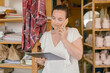 © Dreamwood videography - Mikhail Nilov/Stocksy - Girl with a tablet in an art studio speaks on the phone