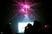 Anonymous People Dancing And A Purple Mirrorball
