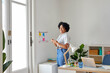 © ALTO IMAGES/Stocksy - Cheerful black woman in office