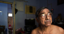 Headshot Portrait Of A Senior Citizen Inside Room