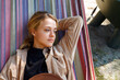 © Danil Nevsky/Stocksy - Dreamy woman resting in hammock