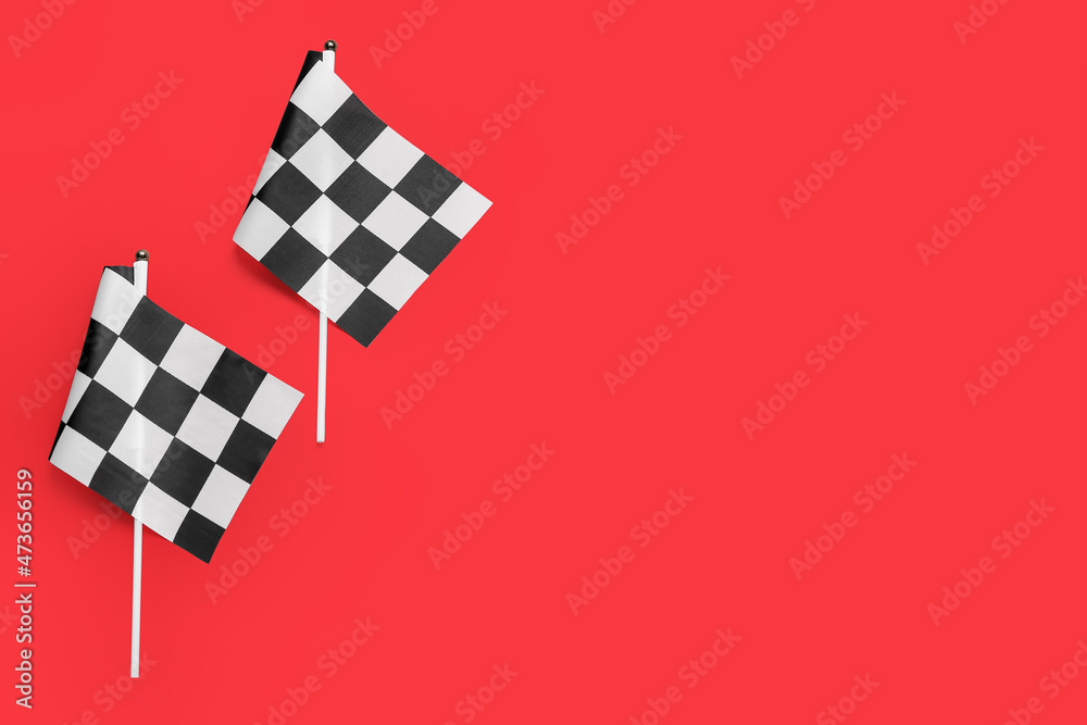 Racing flags on color background, top view