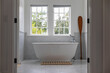 © Raymond Forbes Photography/Stocksy - Stylish  Bathroom in home with large white bathtub