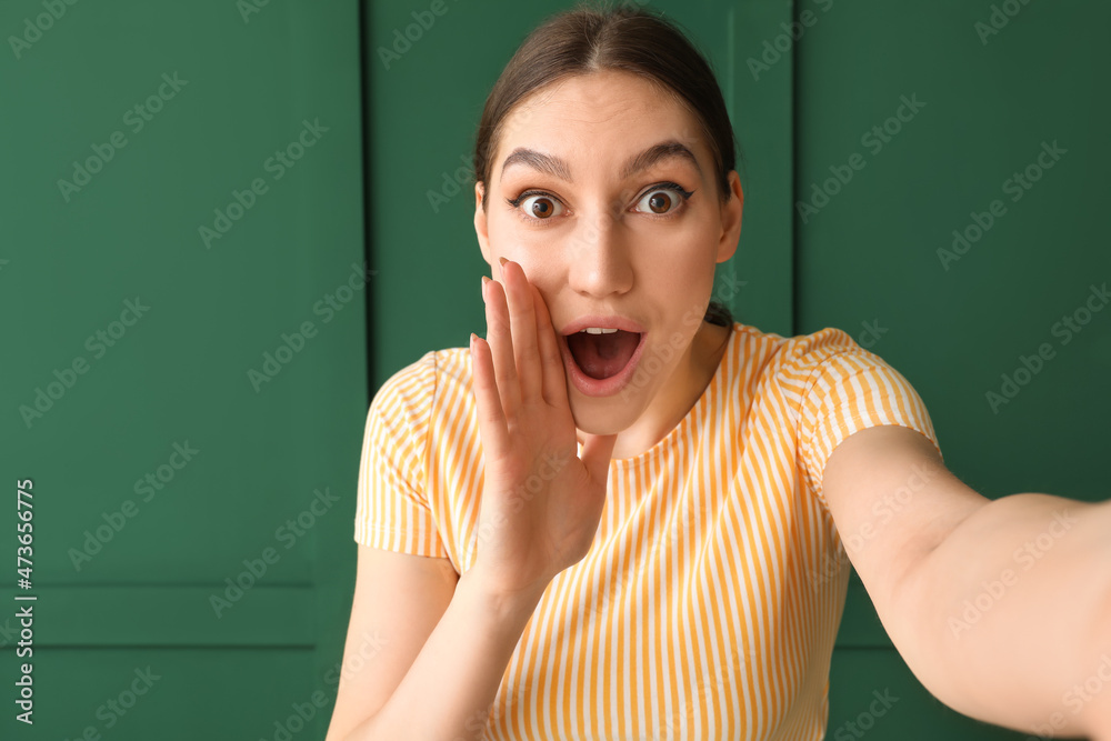 Young gossiping woman on color background