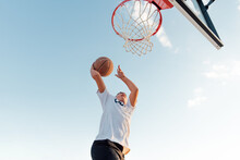 Boy Dunking Basketball. 