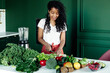 © Sergey Narevskih/Stocksy - Black woman cooking healthy food