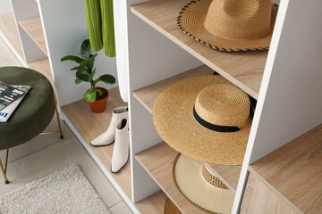 Wall Mural - Stylish straw hats on shelves in wardrobe