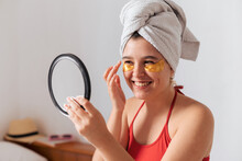 Young Natural Woman Using Under Eye Pads