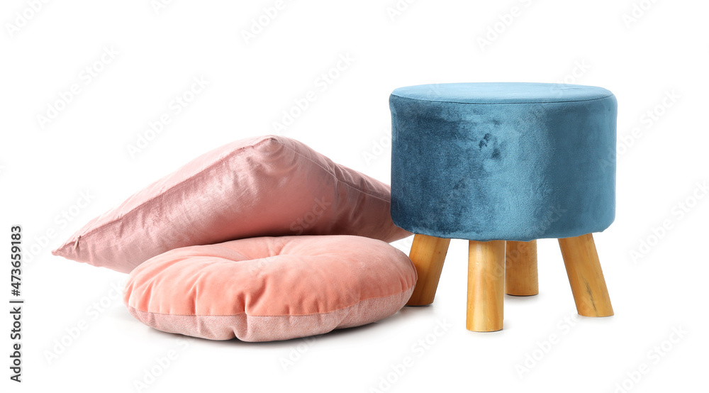 Blue pouf with pink pillows on white background
