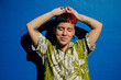 © Ana Luz Crespi/Stocksy - Fun queer transgender man portrait enjoying the sun