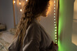 © Eloisa Ramos/Stocksy - Beautiful woman in bedroom lit