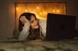 © Eloisa Ramos/Stocksy - Girl watching movies on the bed