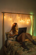 © Eloisa Ramos/Stocksy - Woman on the bed with the laptop