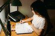 © Eloisa Ramos/Stocksy - Teen student doing homework at night