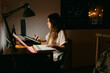 © Eloisa Ramos/Stocksy - Female doing homework in her room at night