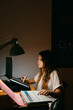 © Eloisa Ramos/Stocksy - Teen student studying at night
