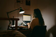 © Eloisa Ramos/Stocksy - Female studying in her room at night