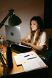 © Eloisa Ramos/Stocksy - Pretty teen girl studying in her room at night