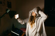 © Eloisa Ramos/Stocksy - Cool teen girl taking selfies in bedroom at night