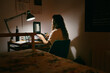 © Eloisa Ramos/Stocksy - Teen girl studying in her room at night
