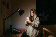 © Eloisa Ramos/Stocksy - Teen girl using her smarphone at bedroom