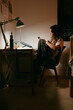 © Eloisa Ramos/Stocksy - Teenager girl using her phone on her desk at night