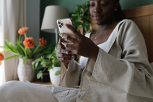 A Black Woman Using A Phone