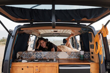Young Woman Inside Camper Van 