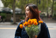 Young Woman With Bouquet Of Flowers