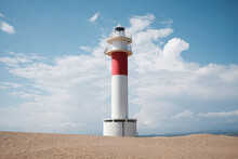 White And Red Lighthouse In The Sand