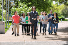 Tour: Guide Leads Group Through College Campus