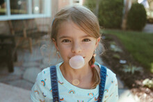Portrait Of Child Blowing A Bubble With Gum