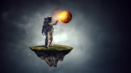 Wall Mural - astronaut walking on an unexplored planet . mixed media