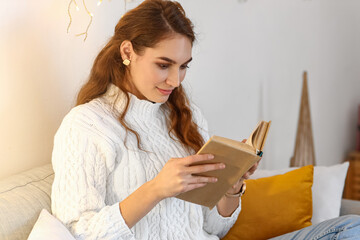 Poster - Pretty young woman reading book at home