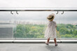 © Rein Cheng/Stocksy - Back view baby playing with bubble machine on the balcony