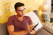 © Ivan Gener/Stocksy - Man writing in his journal at home