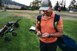 Golfer using mobile phone on golf course