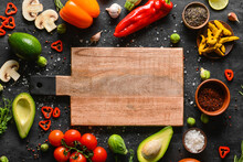 Wooden Cutting Board With Tasty Food And Spices On Dark Background