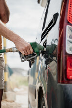 Close-up Of Man Refilling The Fuel  Tank In Gas Station