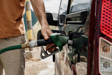 Close-up Of Man Refilling The Fuel  Tank In Gas Station