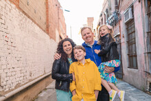 Happy Family Of Four In Alley