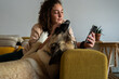 © Eloisa Ramos/Stocksy - Teenager texting with her dog